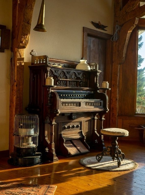 Period interior with an antique parlour organ awaiting appraisal